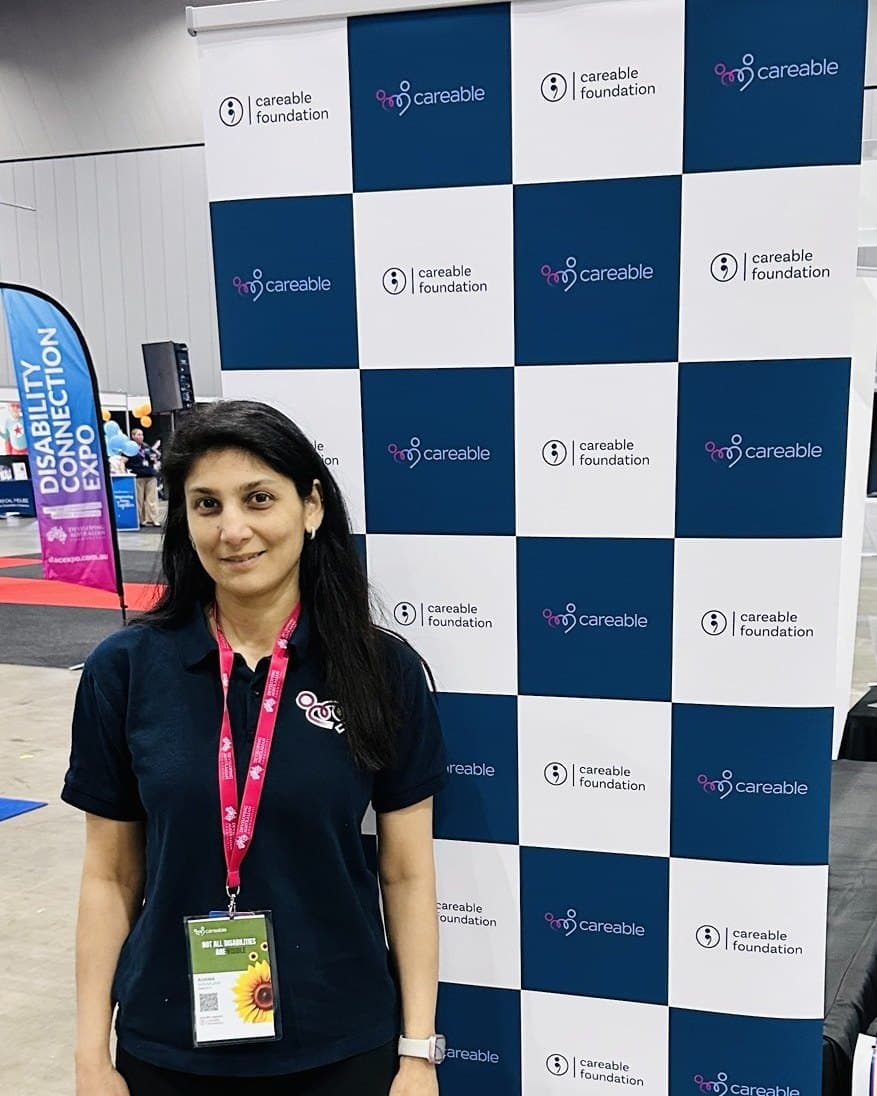 Ashima, Head of CX, in front of the Careable backdrop